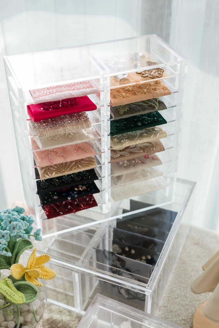 Hand-beaded fabric swatches in the Studio Mehek atelier