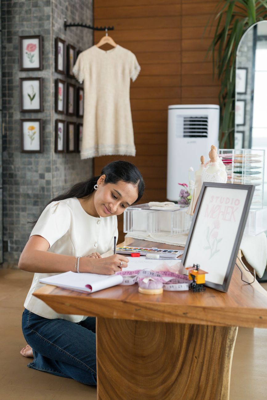 Mehek Sanghvi, founder of Studio Mehek, sketching at her atelier desk
