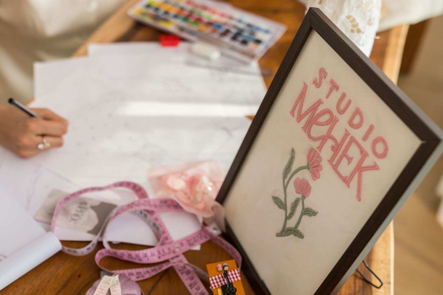 The Studio Mehek atelier — sketches, watercolours and a hand-embroidered studio sign