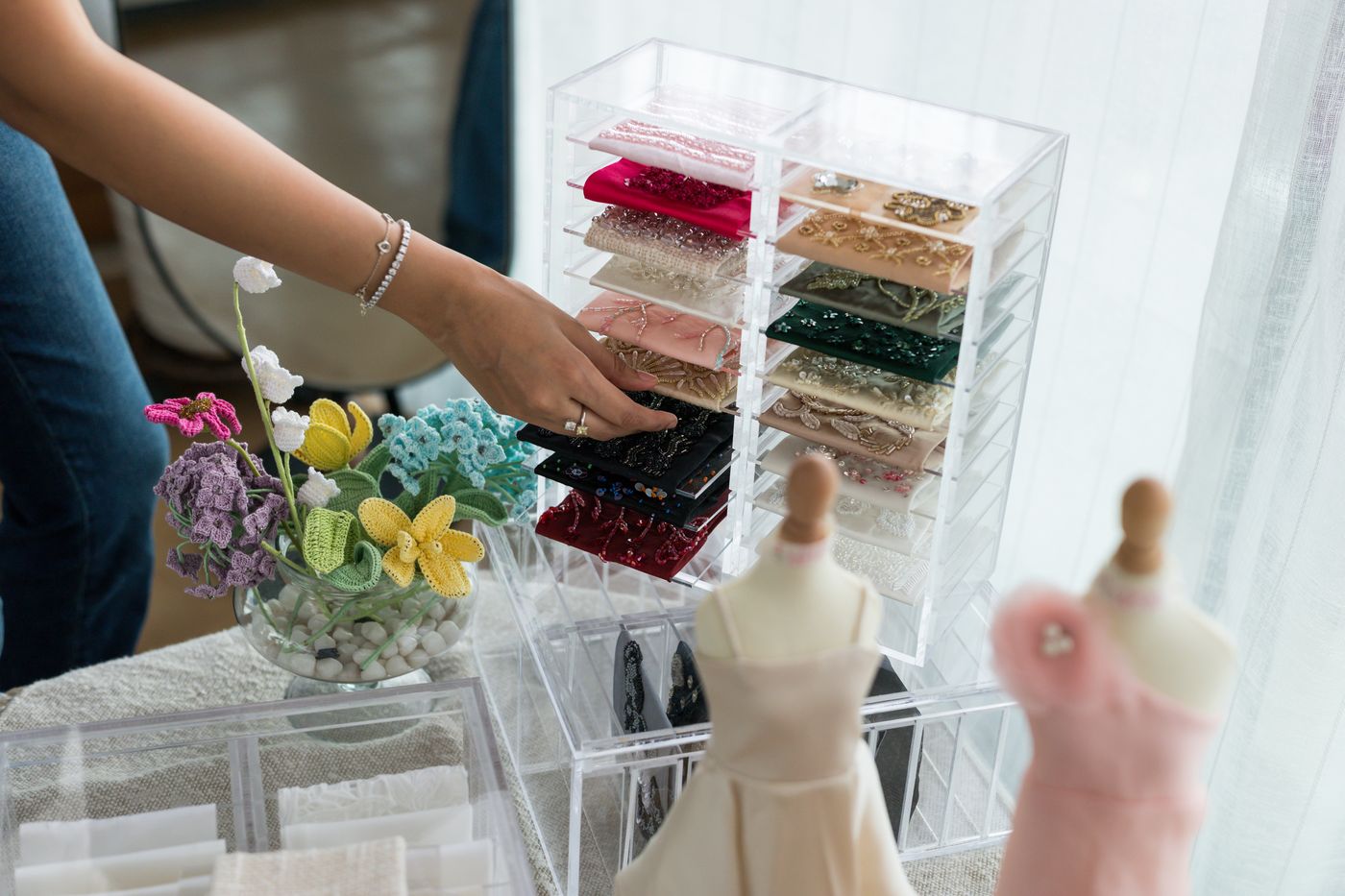 Selecting hand-embroidered fabric swatches at Studio Mehek