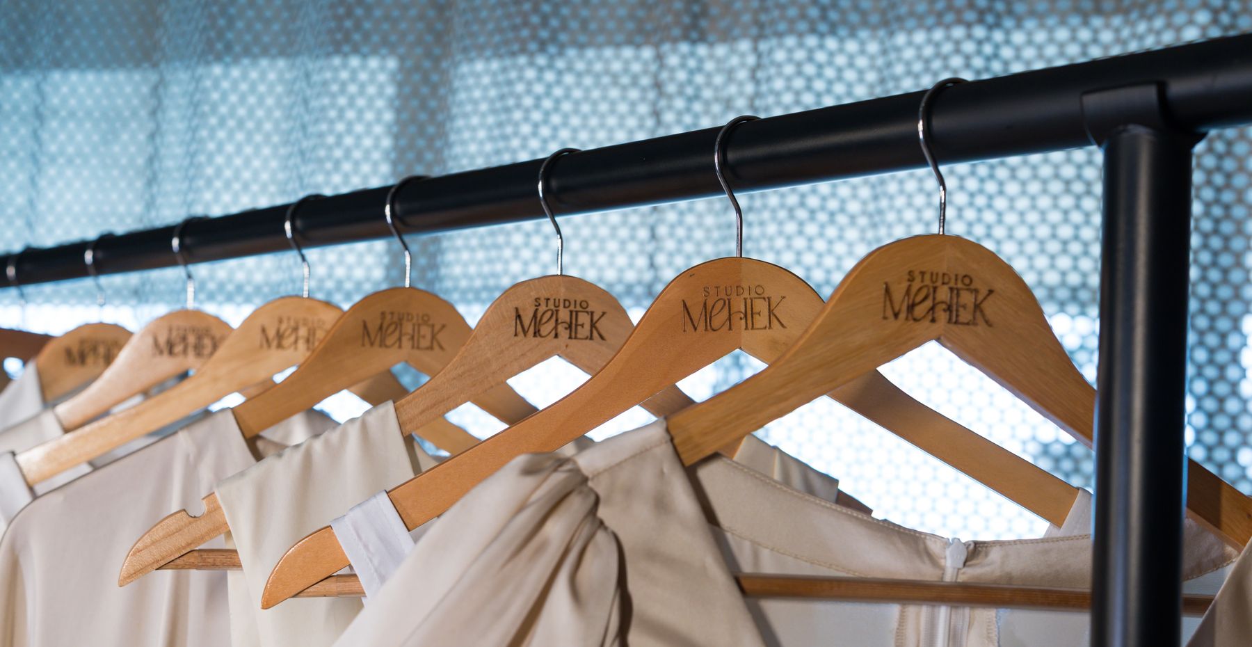 Studio Mehek branded wooden hangers in the atelier